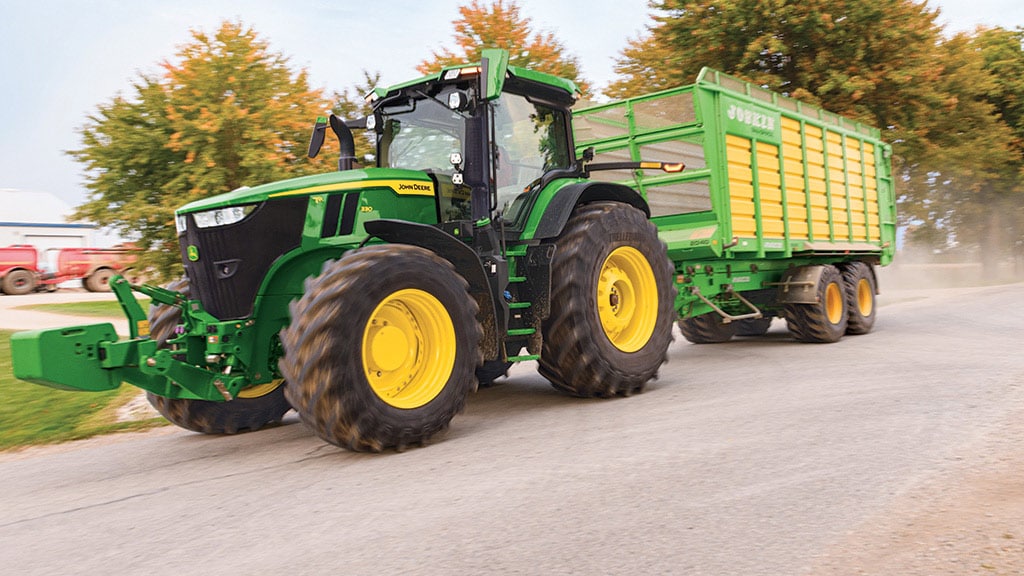 7R tractor driving down road