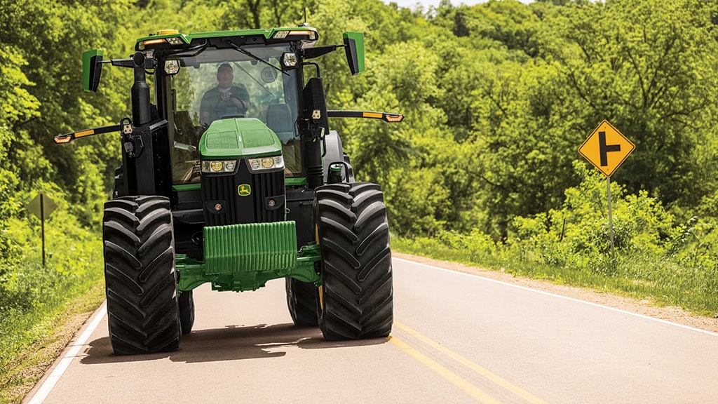 7R tractor driving down road