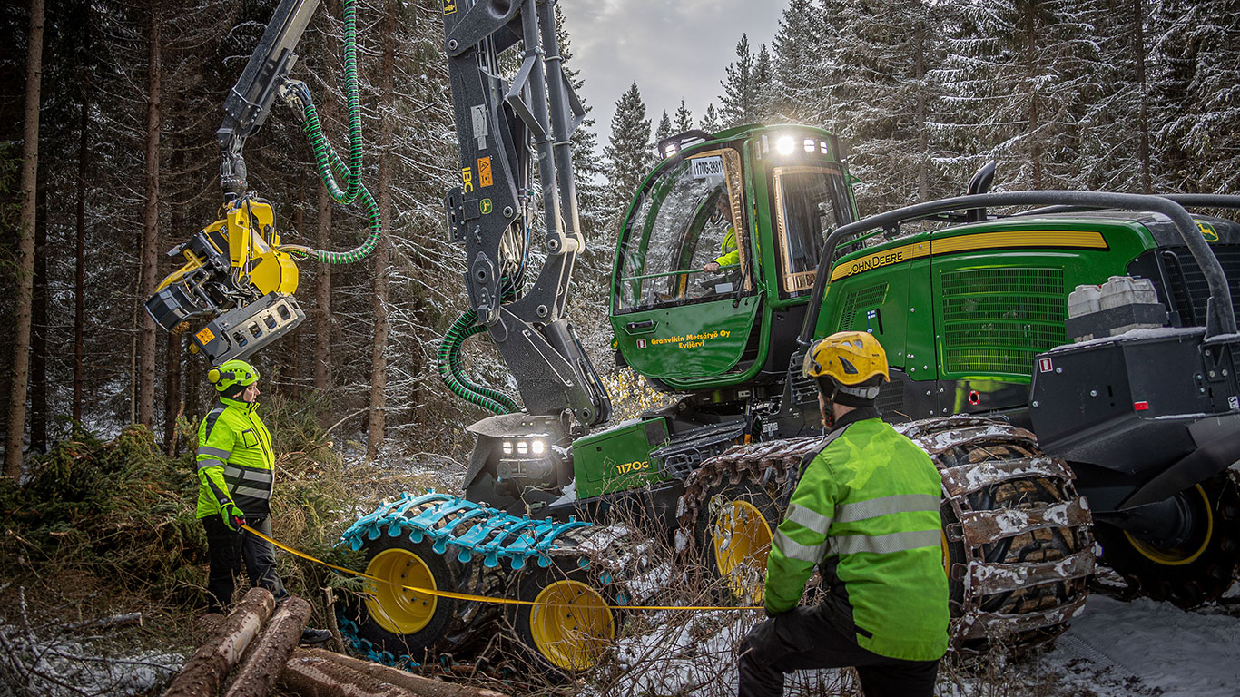 pictiure of two men in the woods in front of a Machine