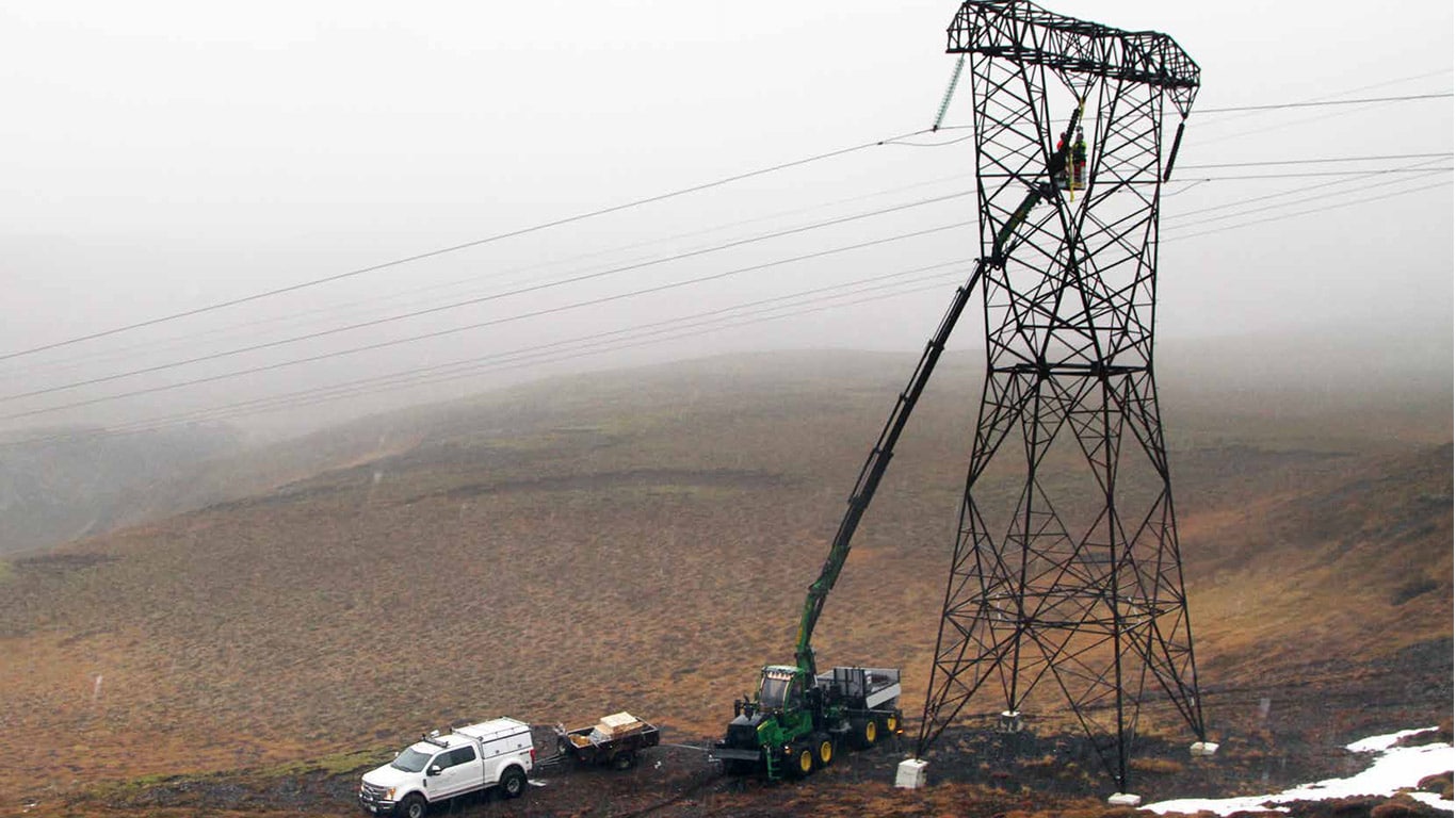 John Deere 1510G and a tall crane lifting a man-carrier