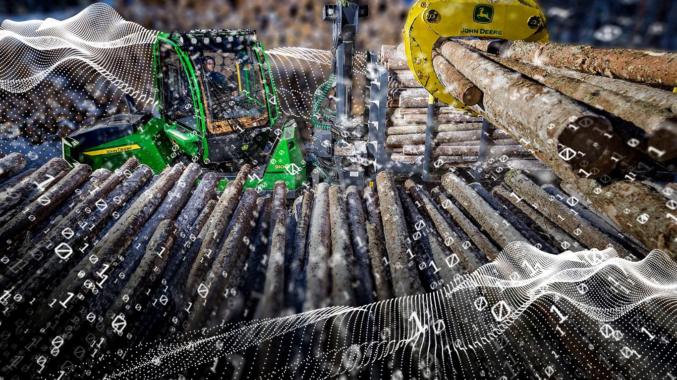 John Deere 910G and piles of wood