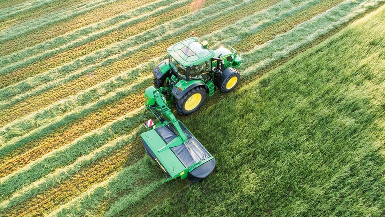 Tractor in field using rear-mounted vertical-fold R310R