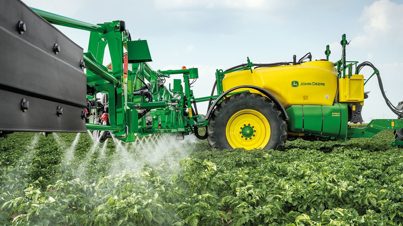 close up view of a sprayer in action in a field