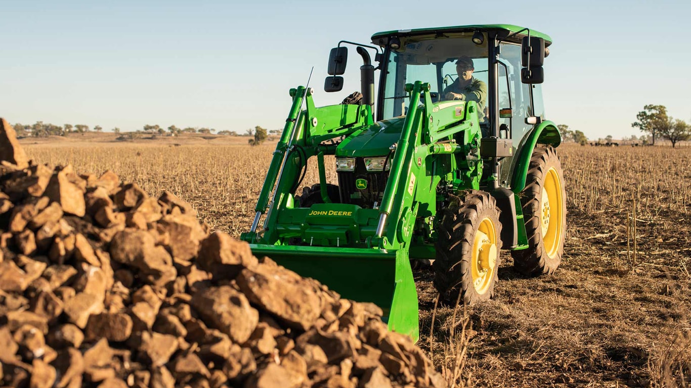 Man on utility tractor