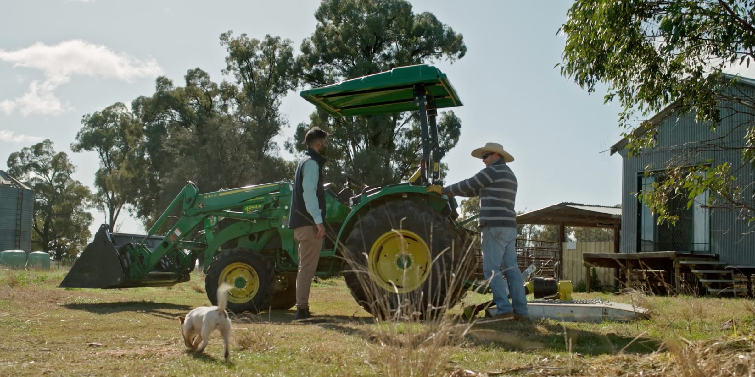 Will and his local John Deere dealer standing by Will's John Deere tractor