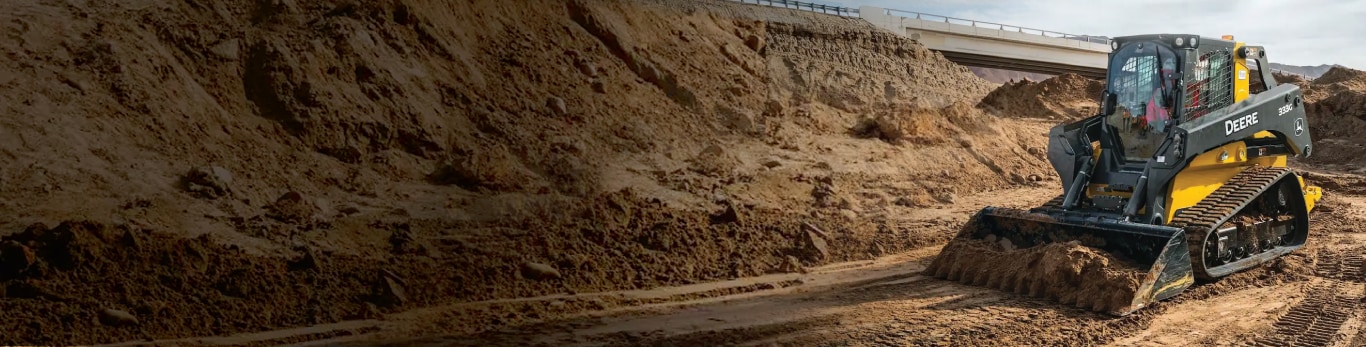 Skid Steer pushing dirt in a construction area