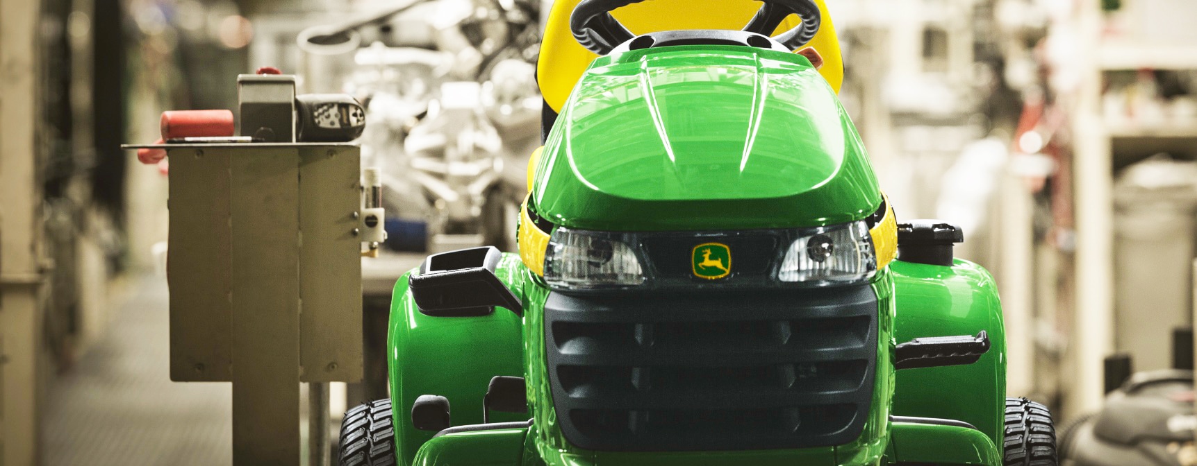 front-view of a Deere mower in a factory