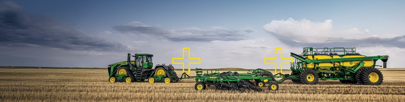 Row crop tractor pulling cutters and spraying equipment through a field