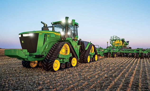 Tractor pulling tillage equipment through field