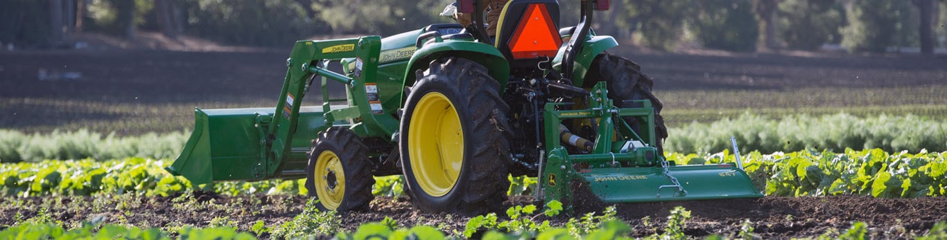 image of tractor in field with attachments