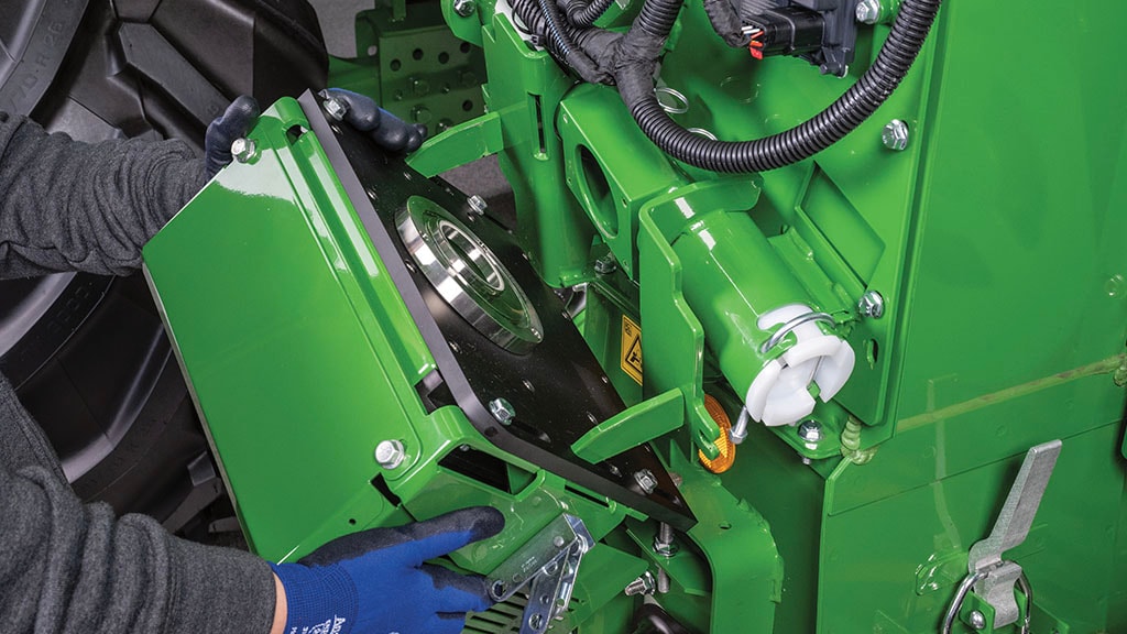 CU photo of a John Deere technician installing a HarvestLab™ 3000 unit on a John Deere Combine