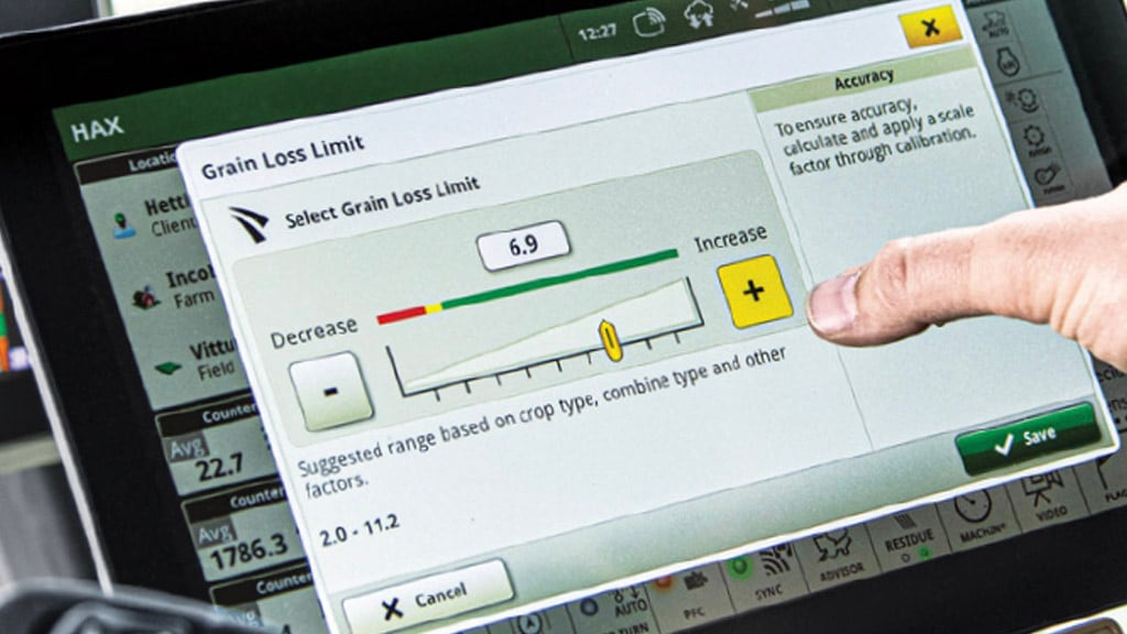 Close-up photo of a farmer's hand adjusting the Grain Loss Limit run page on a G5Plus Display