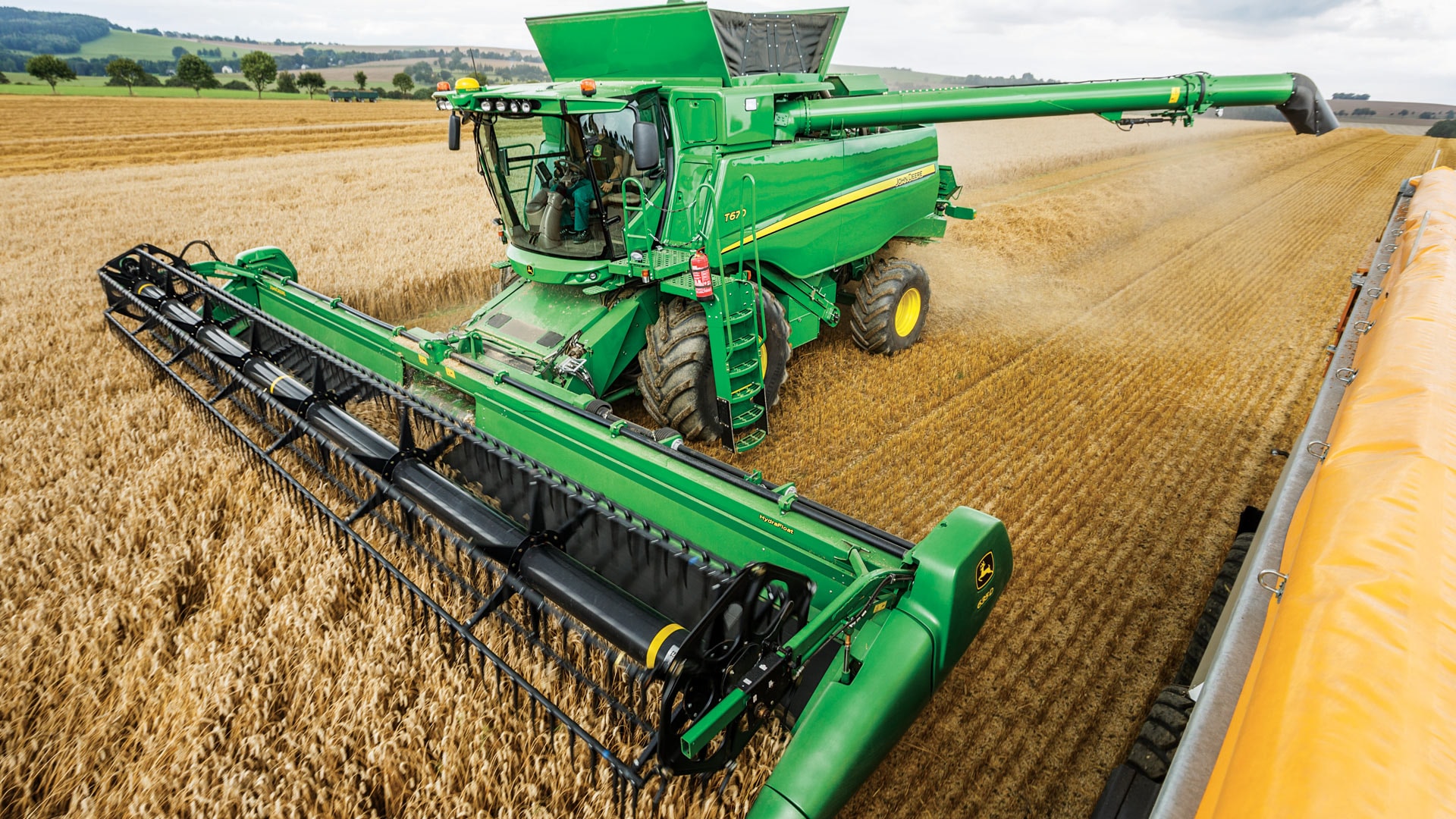 John Deere T-Series combine harvester harvesting crops.
