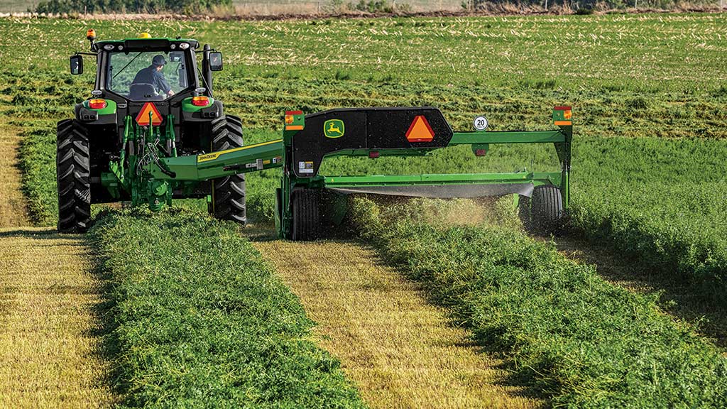 tractor and mower conditioner in a field