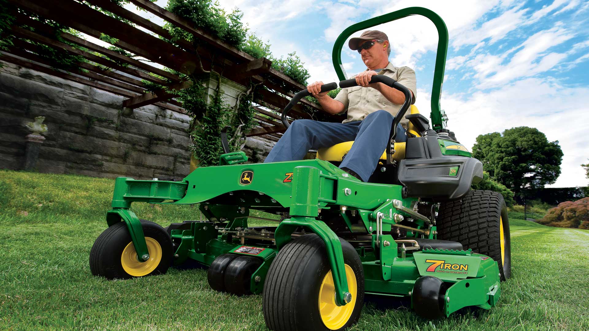 Man mowing using a commercial zero-turn mower from John Deere AU.	