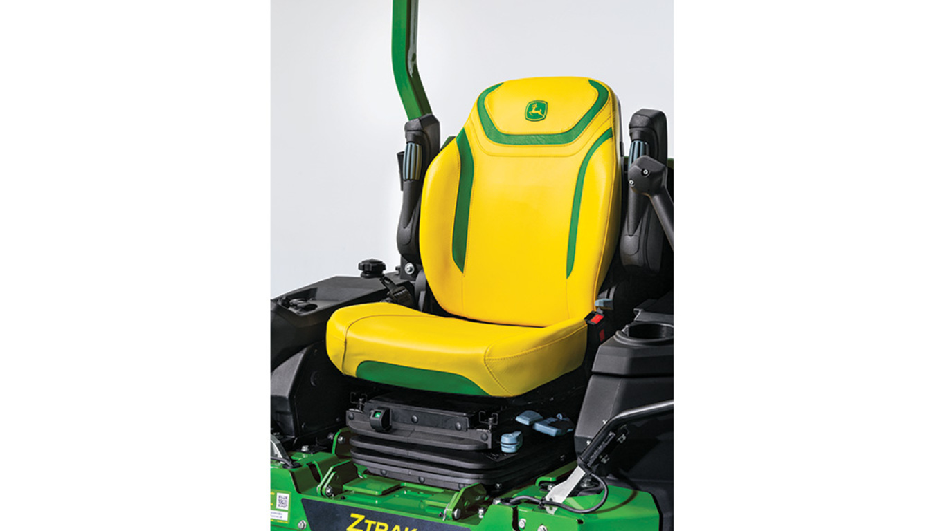 Close-up shot of a yellow air-suspension seat with green detailing on a zero-turn mower.