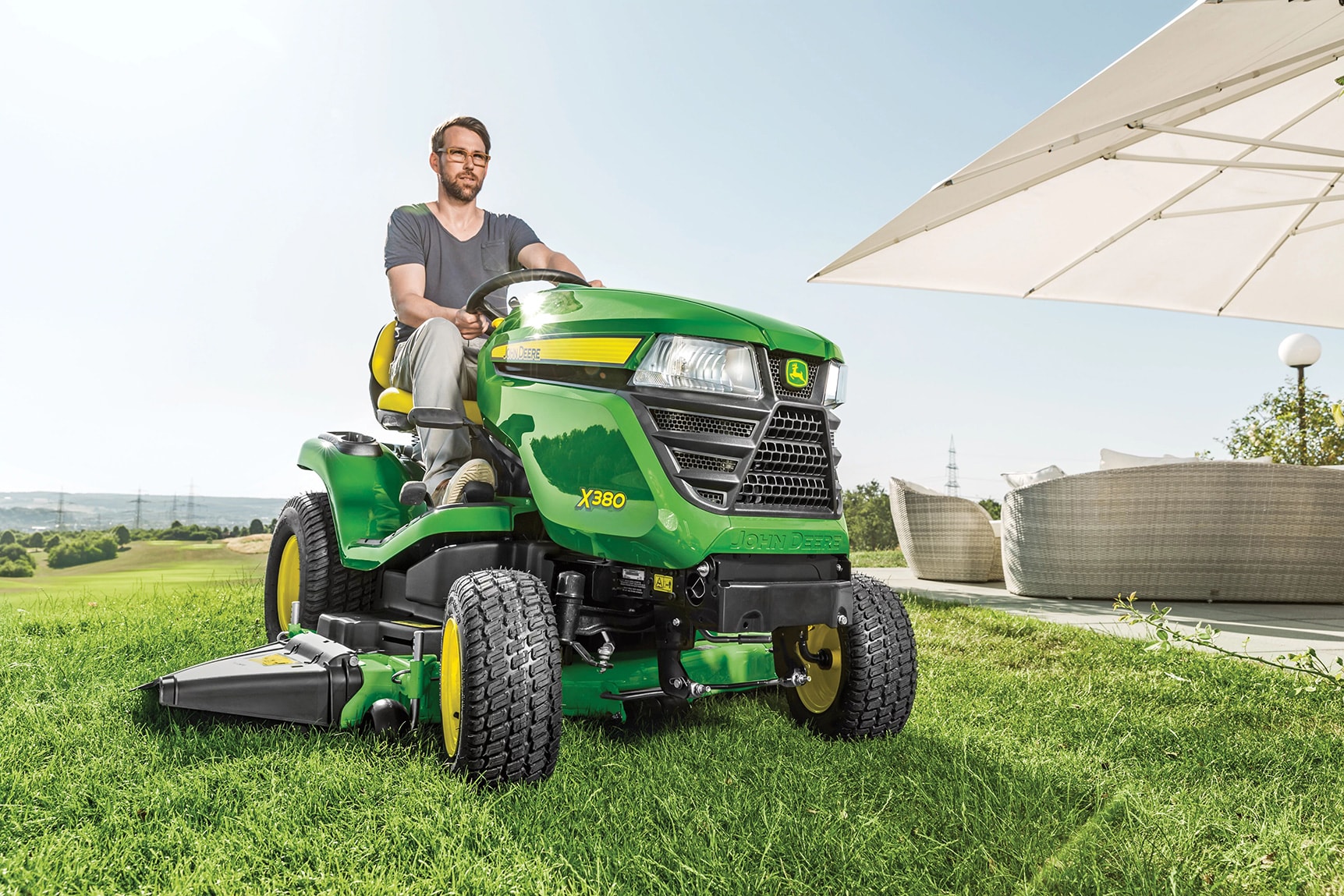 homeowner on tractor in lawn