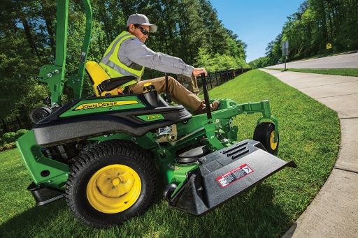 A man easily mowing sidewalk with 7-Iron Mower deck from John Deere AU.