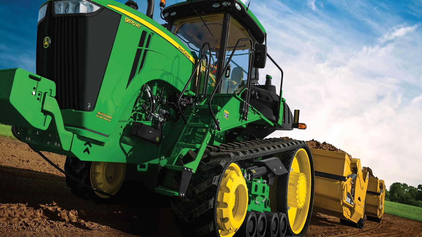 image of tractor pulling a scraper in a field