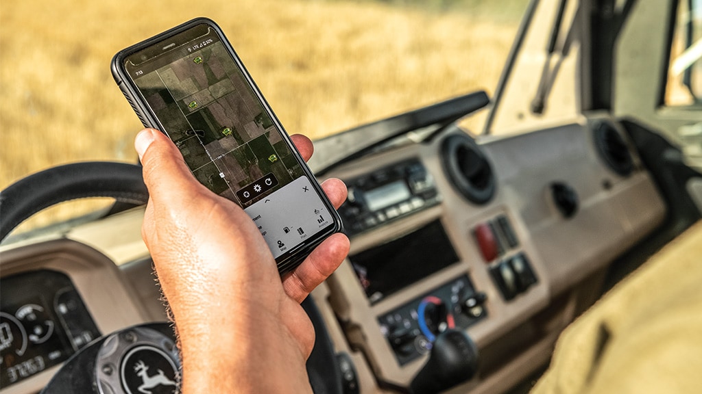 Close up image of John Deere Operations Center showing on a mobile phone in hand.