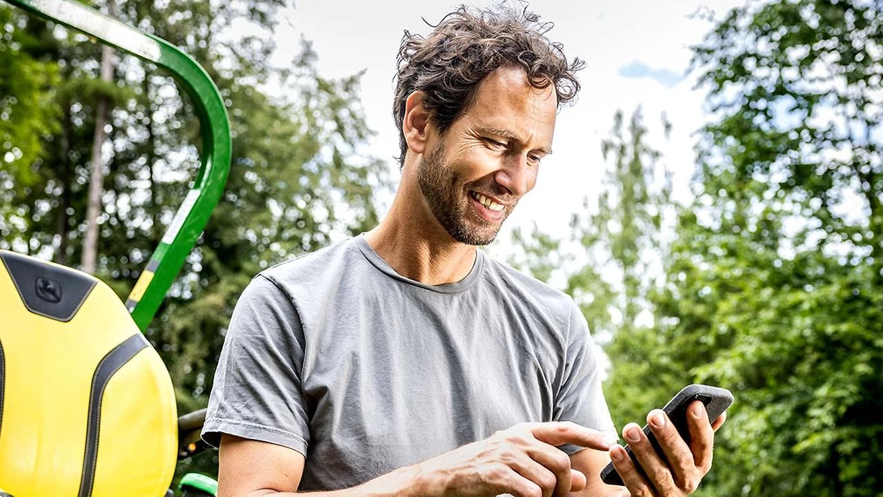 landscaper using precision turf apps on mobile device