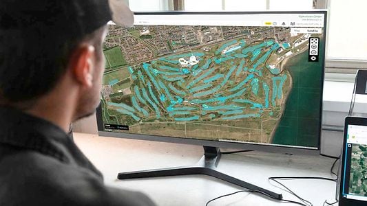 man using precision turf manage boundaries on desktop computer