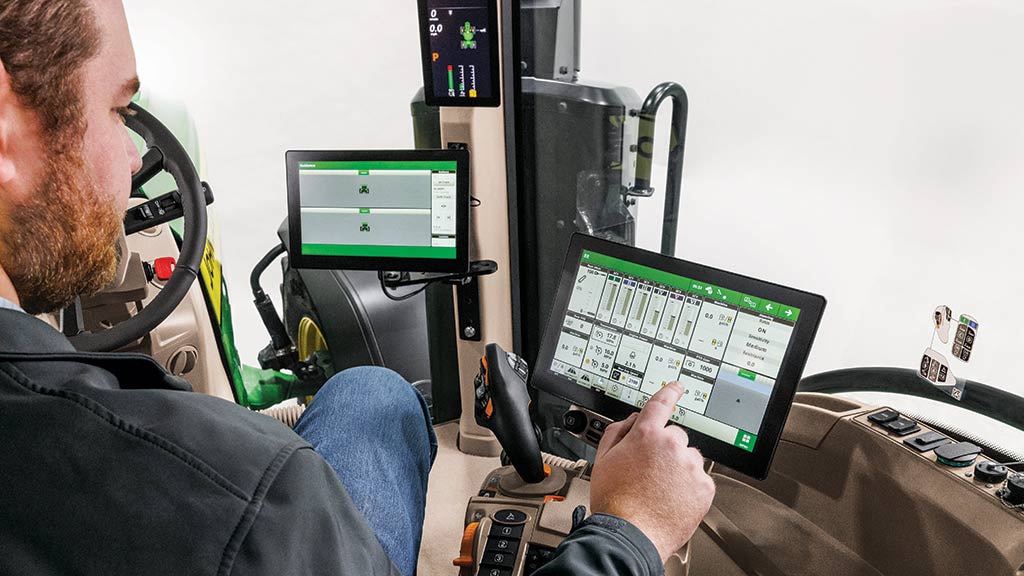 Image of a man interacting with G5Plus display in Tractor cab
