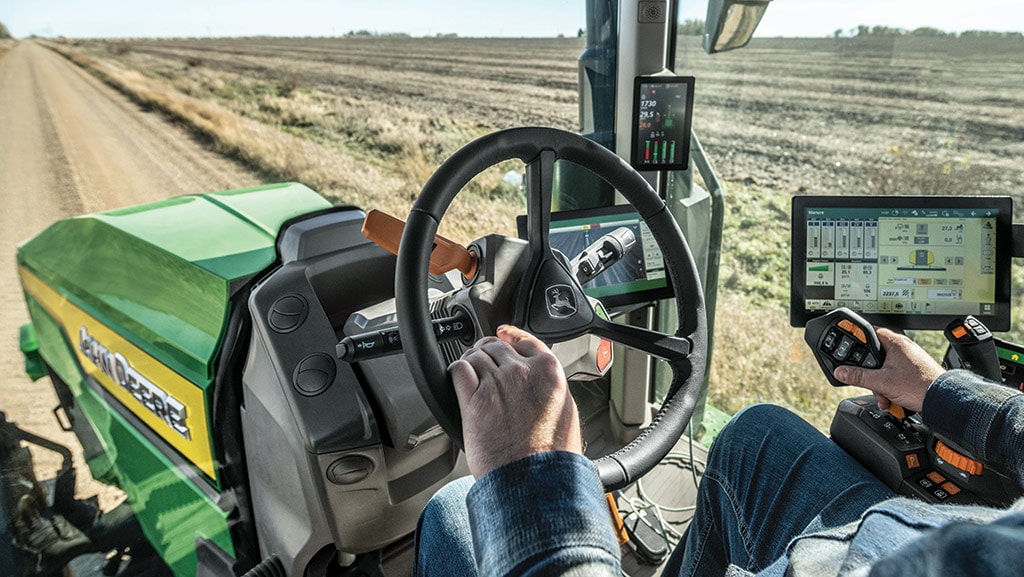 In-cab view of operator driving a high-horsepower 8 Series Tractor.
