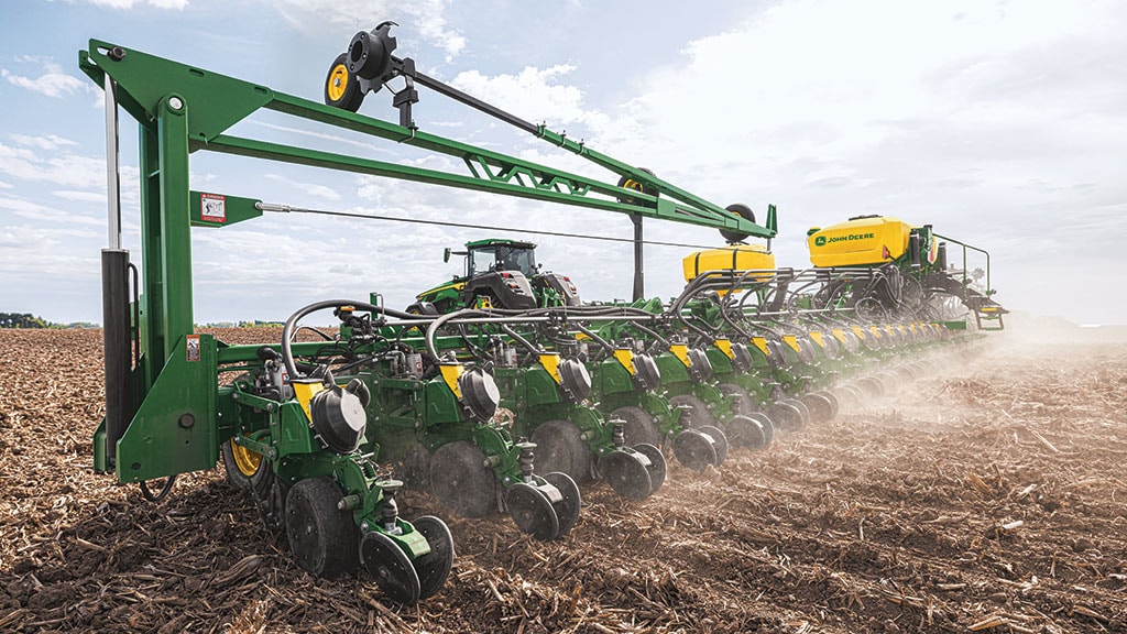 High-horsepower 8R Tractor planting in a field.