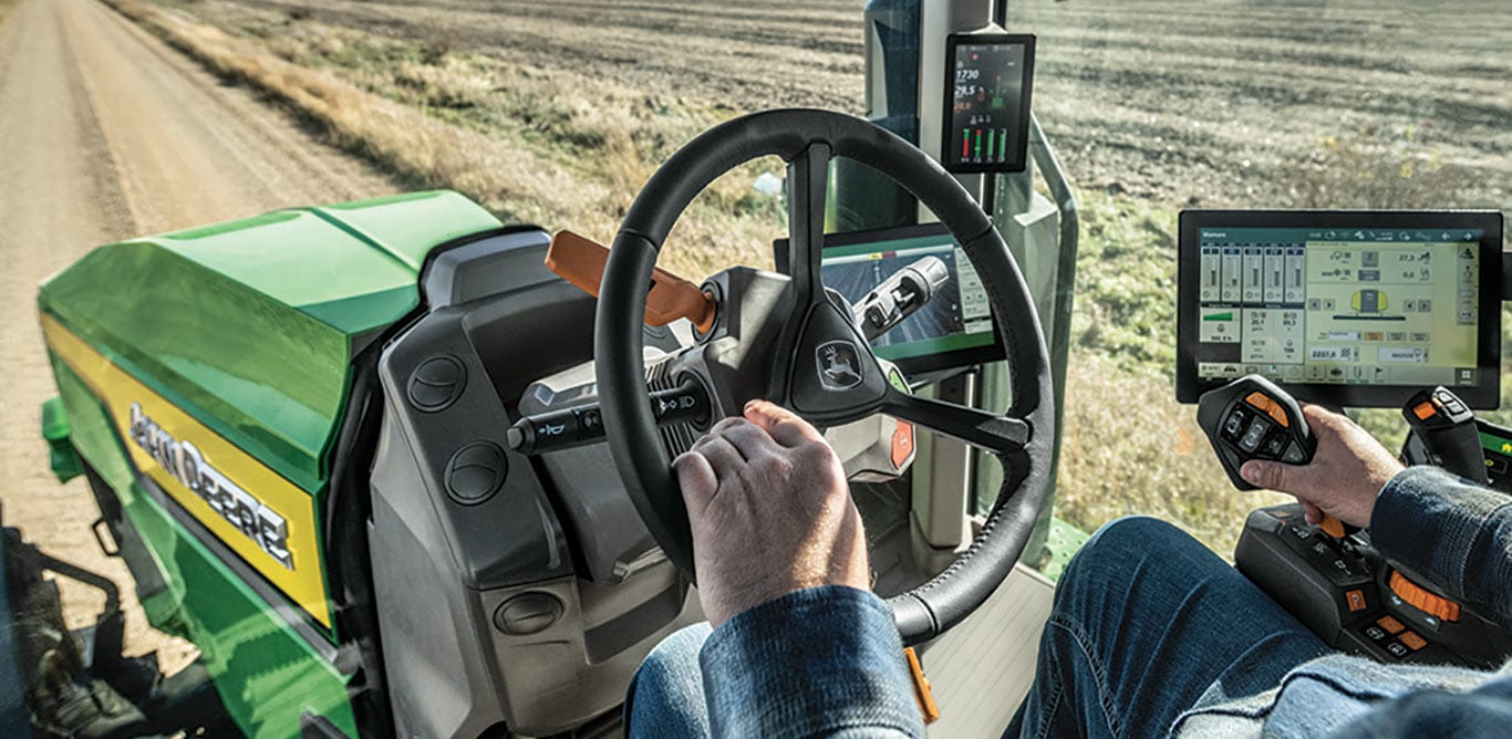 In-cab view of operator driving a high-horsepower 8 Series Tractor.