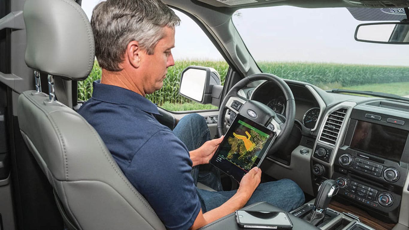 man in truck looking over data