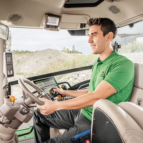 person driving in tractor cab