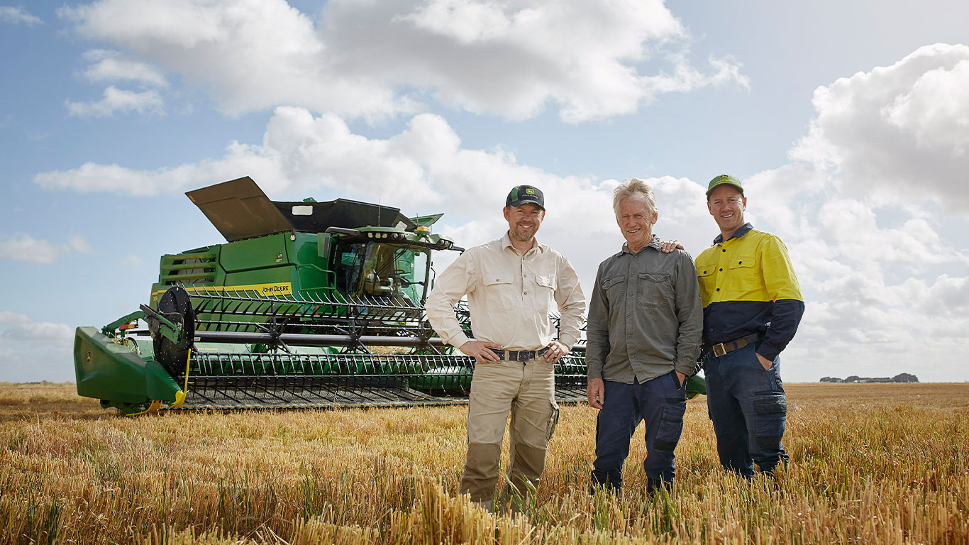 Tim, Luke and Geoff Rethus in the paddock with an X9 Combine.