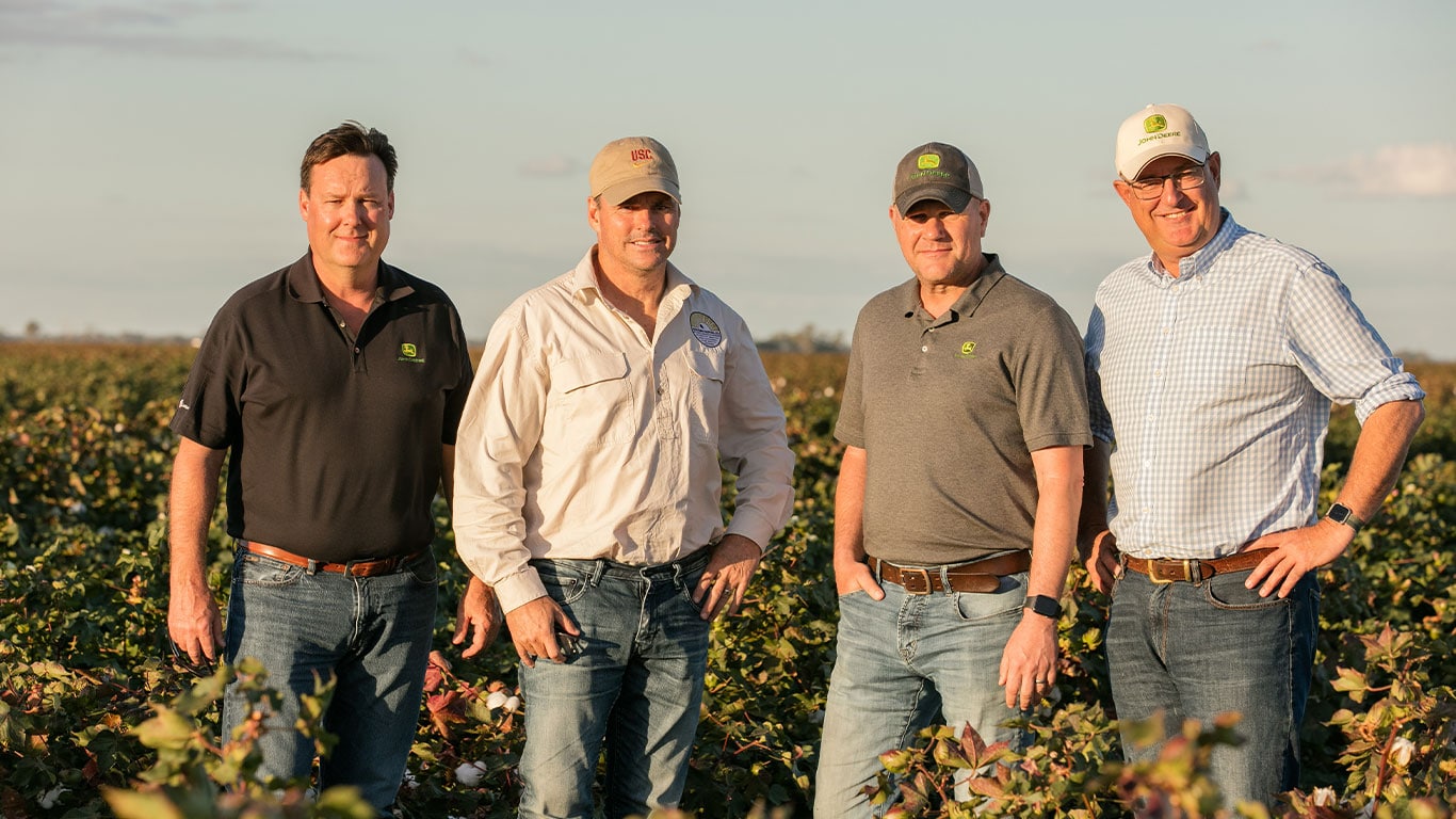 John Deere Global Director, Cotton and Sugar production, Travis Becton, Sundown Pastoral Company owner, David Statham, John Deere Cotton Production System Manager, Steve Young and John Deere Project Engineer, Broughton Boydell, in a cotton field in Moree, NSW.